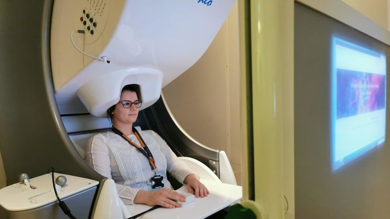 A person in a MEG brain scanner.