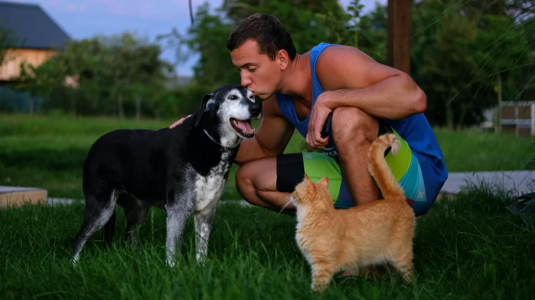 Man with dog and cat